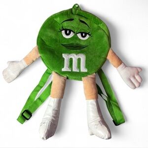 Green M&M's girl backpack with zipper closure, featuring a cute character design